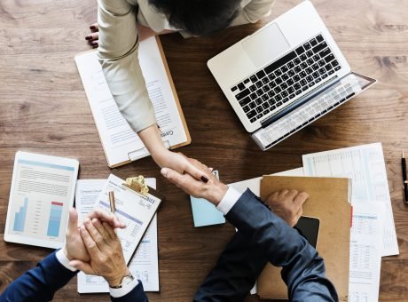 Business people shaking hands together
